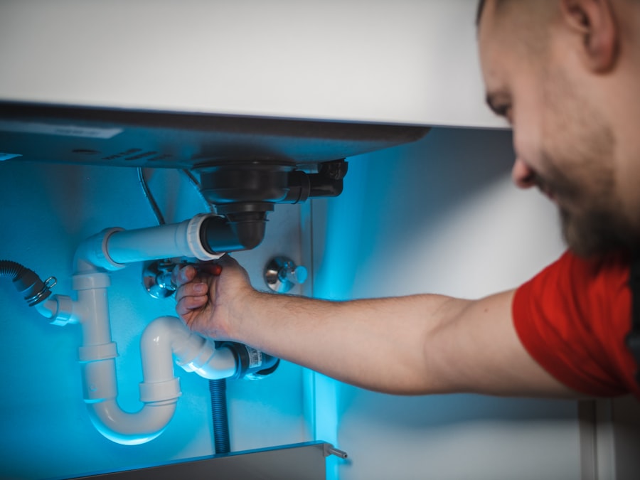 Plumber working on pipes
