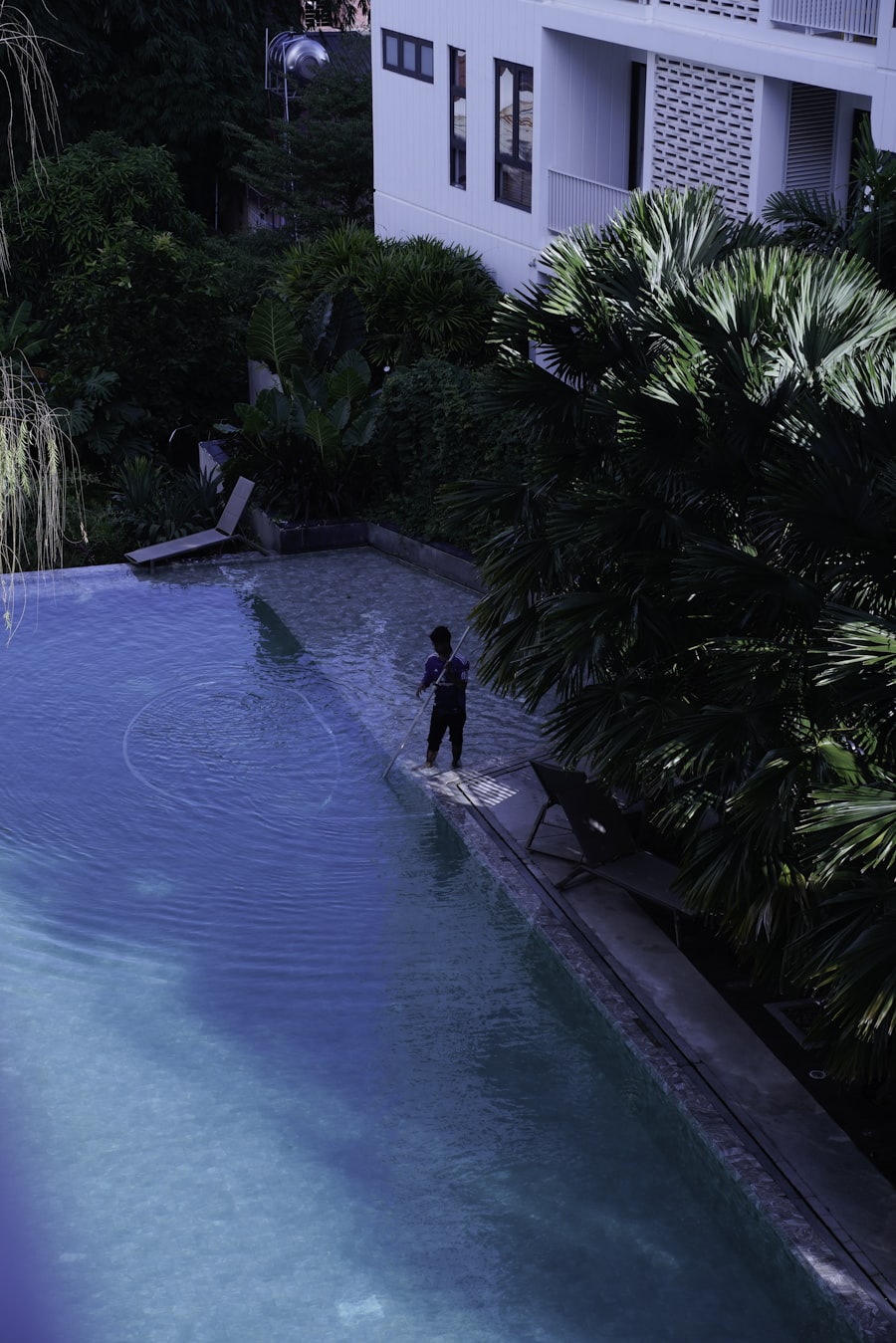 Pool service technician cleaning a pool